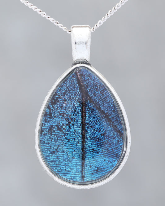 Blue Morpho  - Glow-in-the-dark pendant with an image of a Butterfly's wing set in a blue stone-like bezel