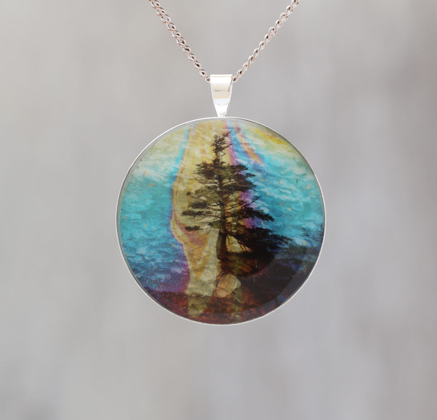Hanging On - Glow-in-the-dark pendant with a surreal image of trees