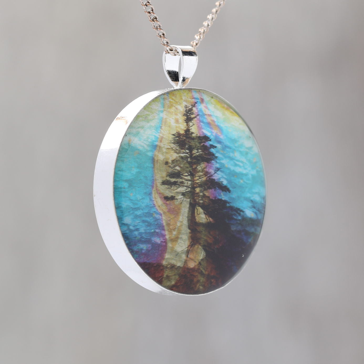 Hanging On - Glow-in-the-dark pendant with a surreal image of trees
